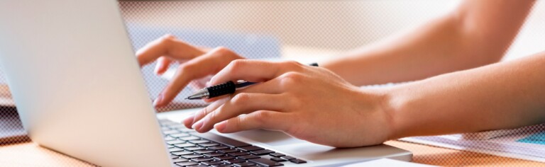 close up of hands typing on laptop keyboard; The Future of Residential Classes Is Hybrid Learning | Collegis Education