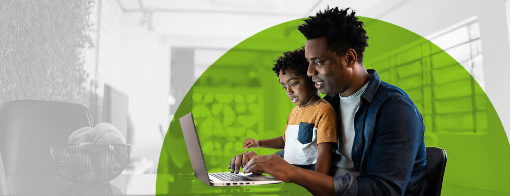 Adult learner studying on laptop at home with child in their lap