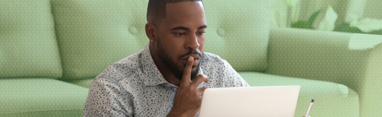 man working on laptop at home; Is There a Stigma Around Online Degrees?