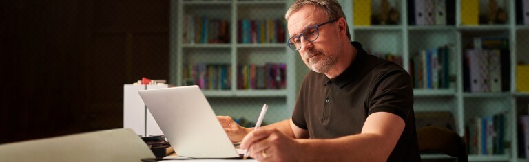 male professor working in office; Acknowledging the Importance of Faculty Training and Development