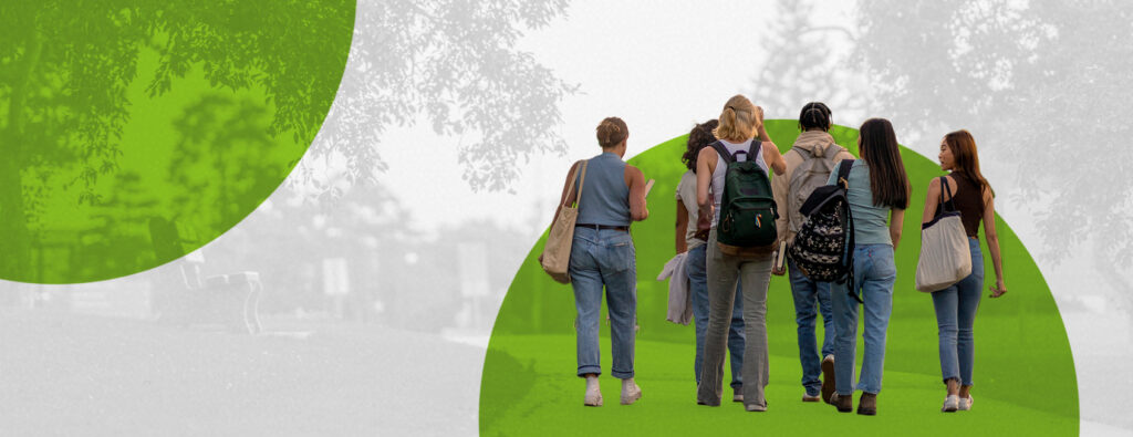 Group of college students walking on campus with backpacks