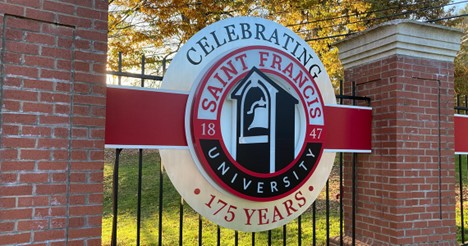Close up shot of the front gates of Saint Francis University